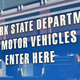 A photo of a sign pointing to the New York DMV office.